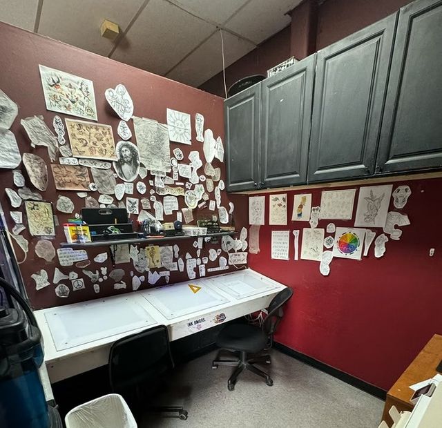 Flash-covered drawing station and light desk where custom tattoo designs get drawn up at American Ink