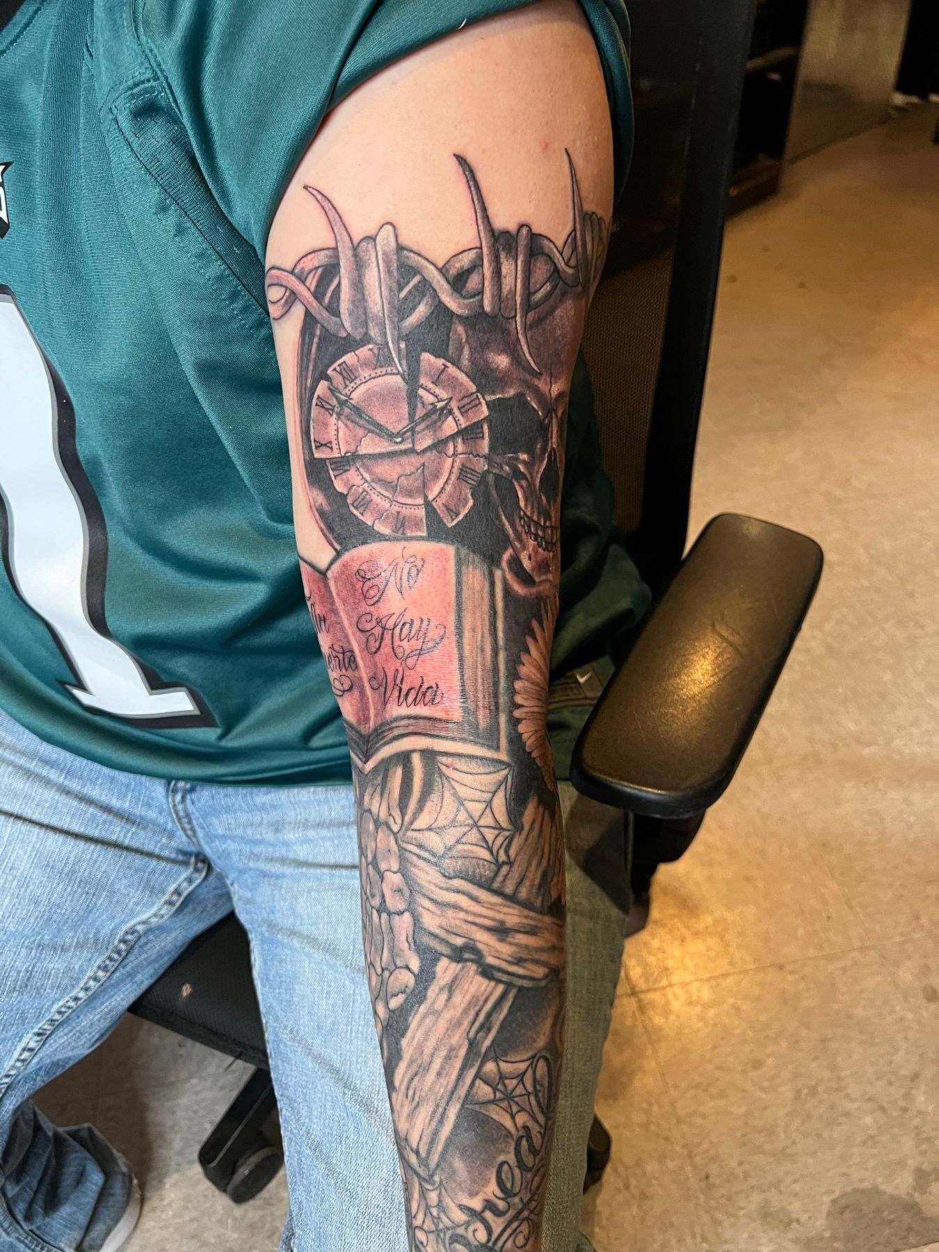 Finished black and grey forearm cover-up of a skull, pocket watch, and eagle with 'Only God Can Judge Me' lettering, by American Ink in Sherman Oaks.