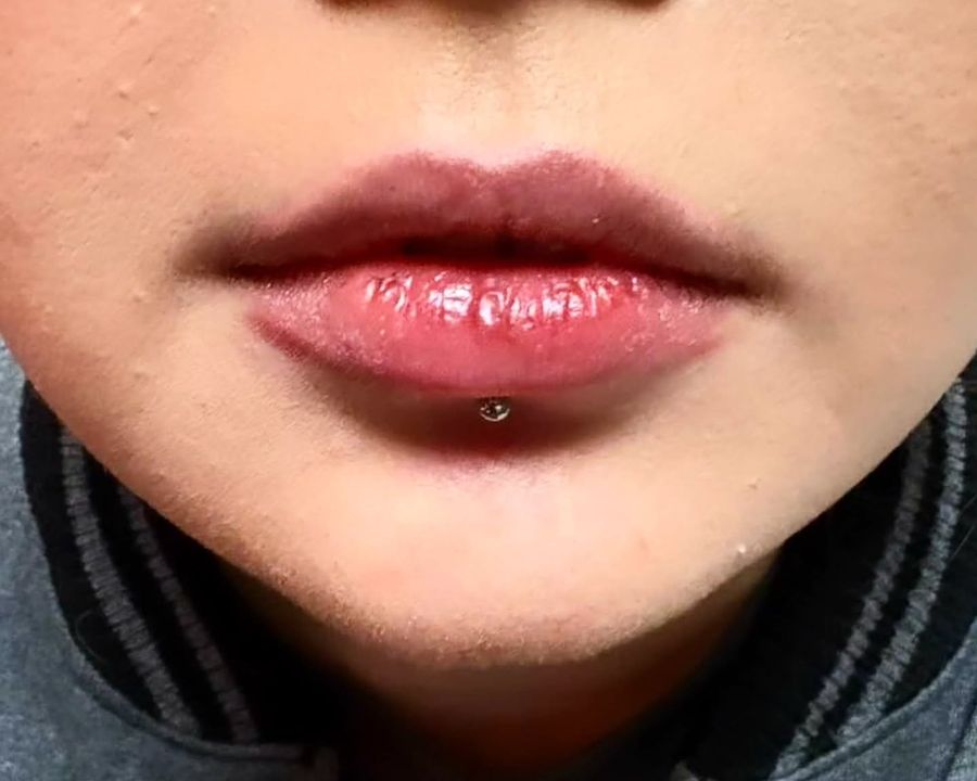 Fresh lower lip labret piercing, set at the American Ink piercing studio