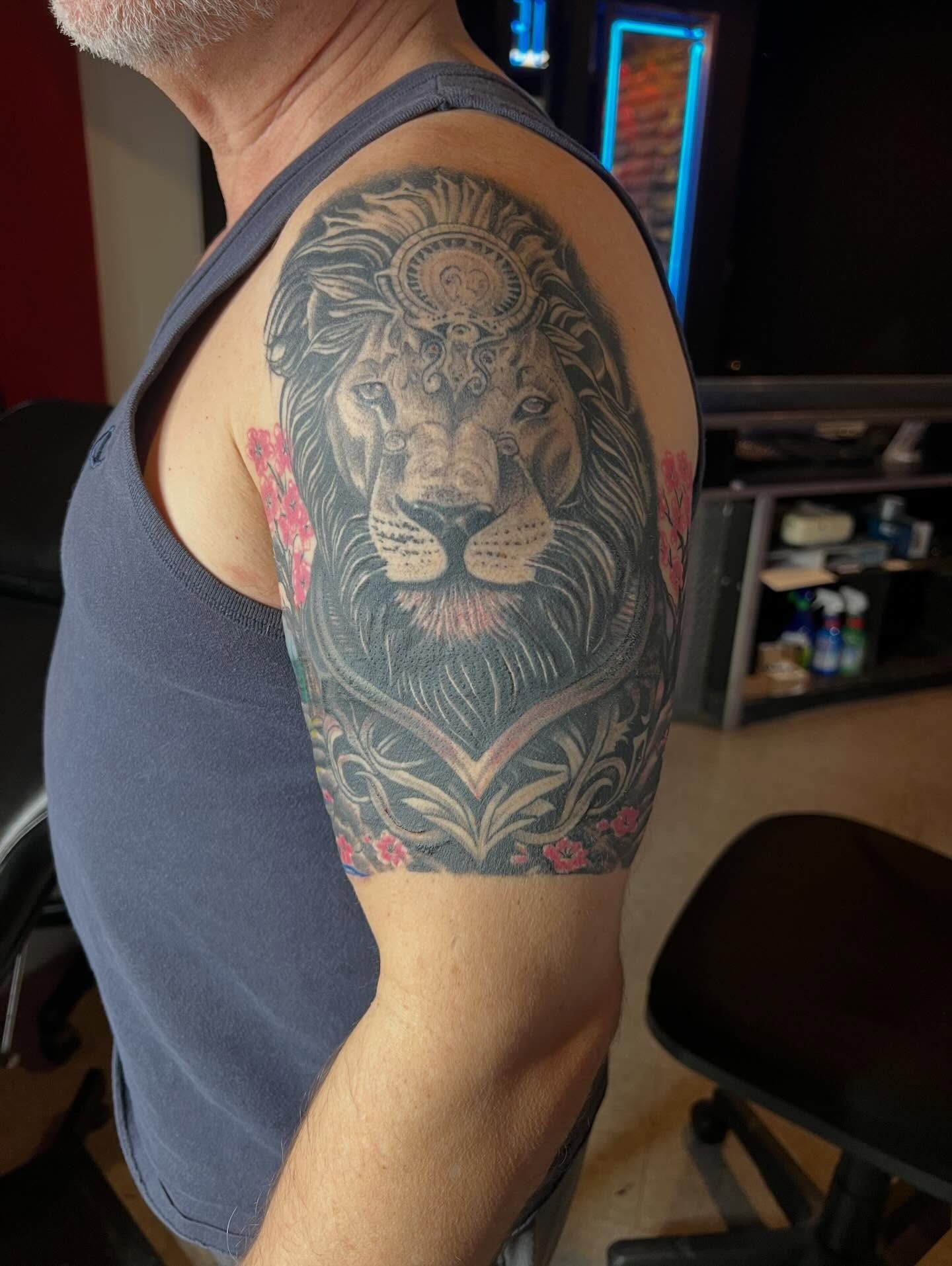 Ornamental lion half-sleeve with floral color accents by Josue at American Ink in Sherman Oaks - the multi-session piece featured in his bio.