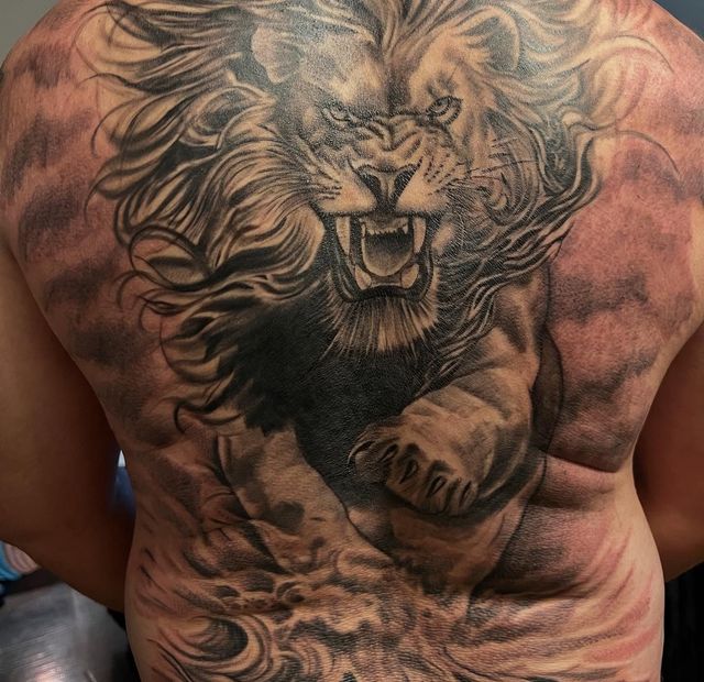 Roaring lion full-back piece in black and grey, tattooed by Josue at American Ink in Sherman Oaks