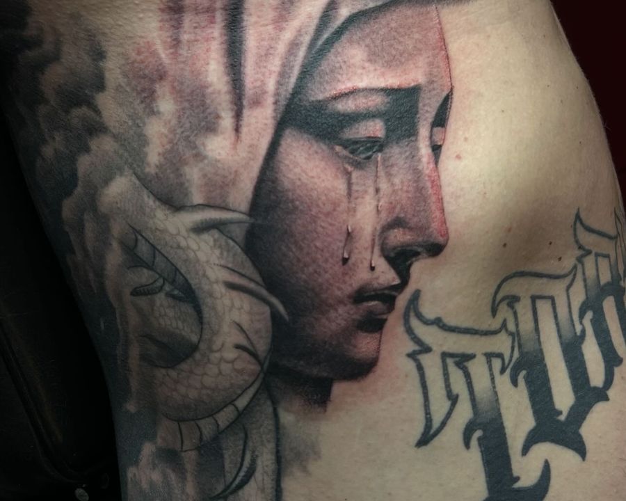 Weeping Madonna rib piece in fine black and grey shading, tattooed by Josue