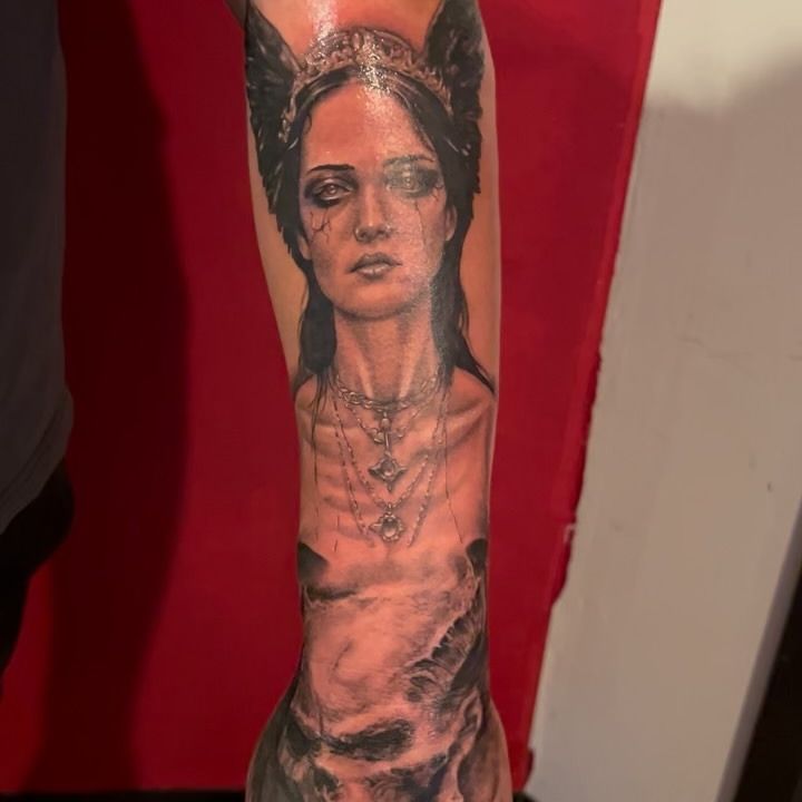 Winged valkyrie portrait forearm piece in dark black and grey, tattooed by Josue