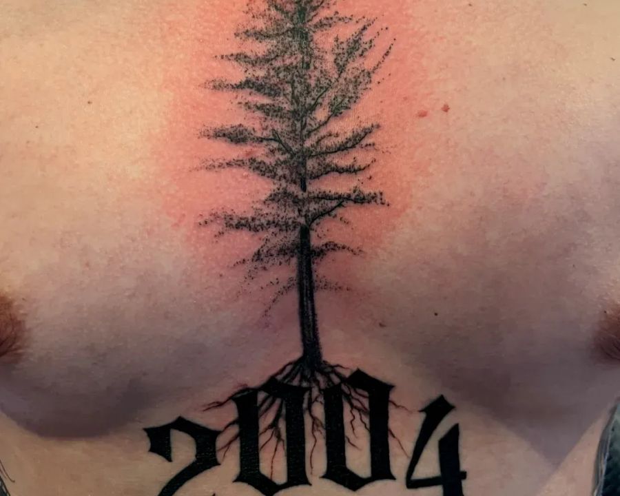Dotwork pine tree chest piece with bold lettering, from the American Ink studio