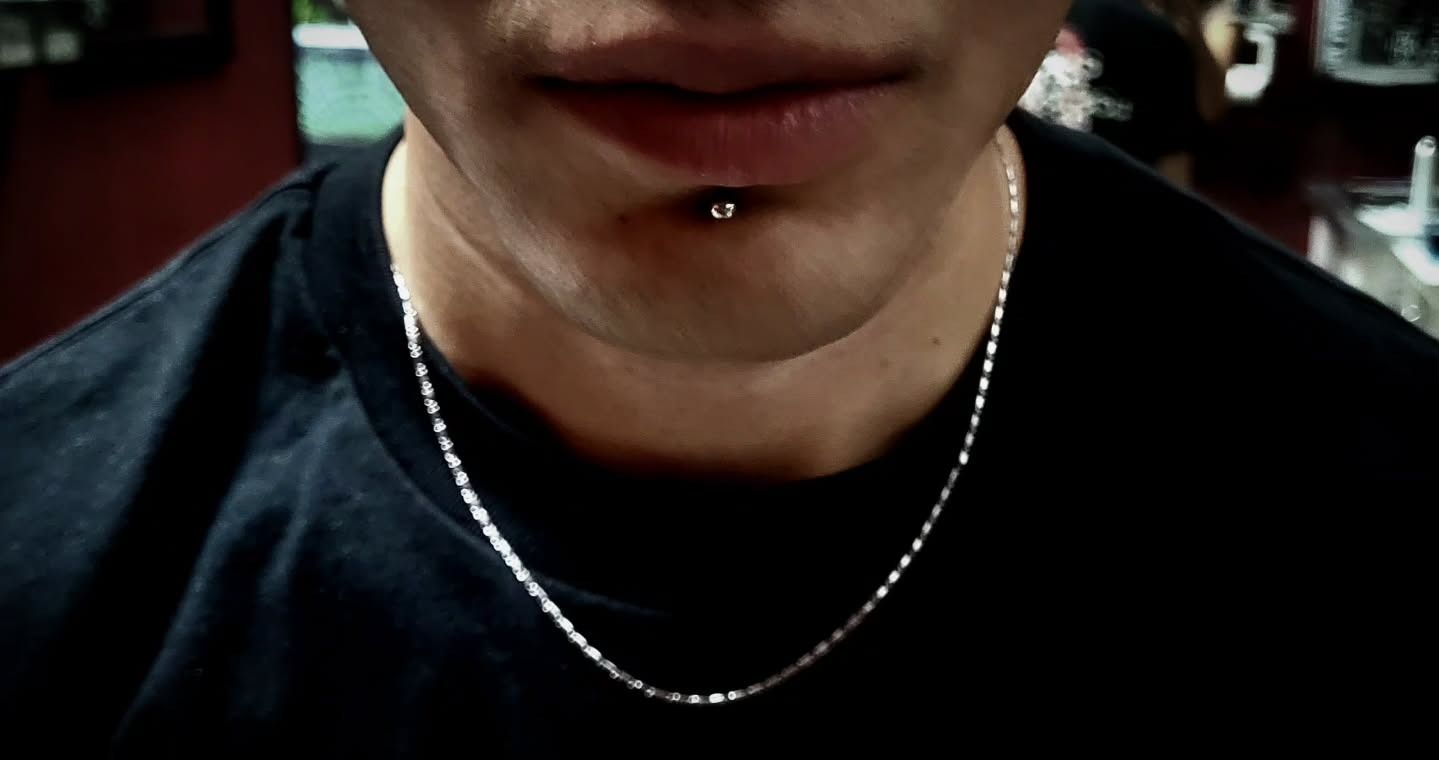Silver labret stud centered below the lower lip, photographed in the American Ink piercing studio in Sherman Oaks.