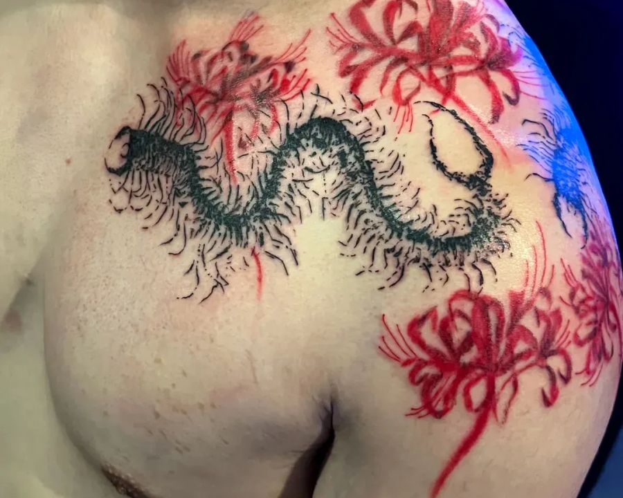 Red spider lily and centipede chest tattoo in illustrative color, from the American Ink studio
