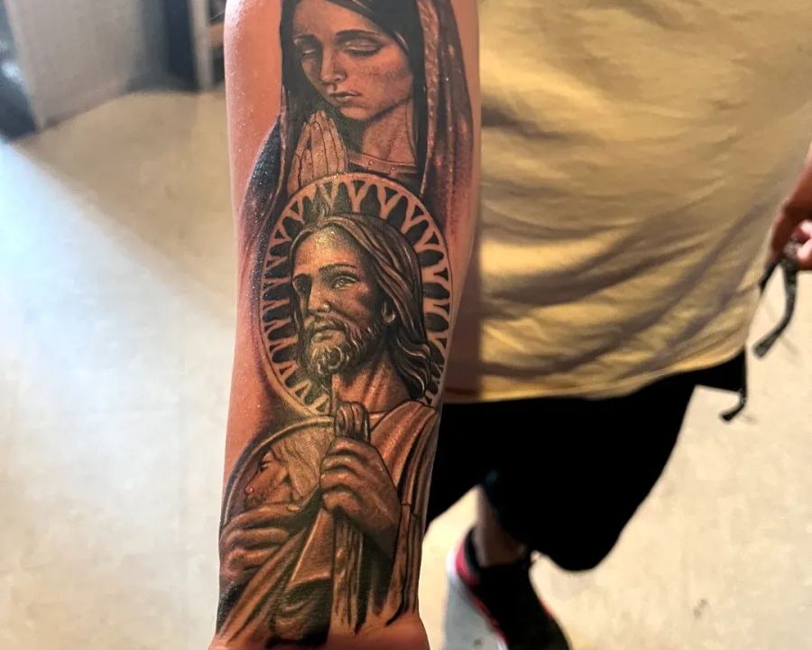 Virgin Mary and San Judas religious forearm sleeve in black and grey, from the American Ink studio