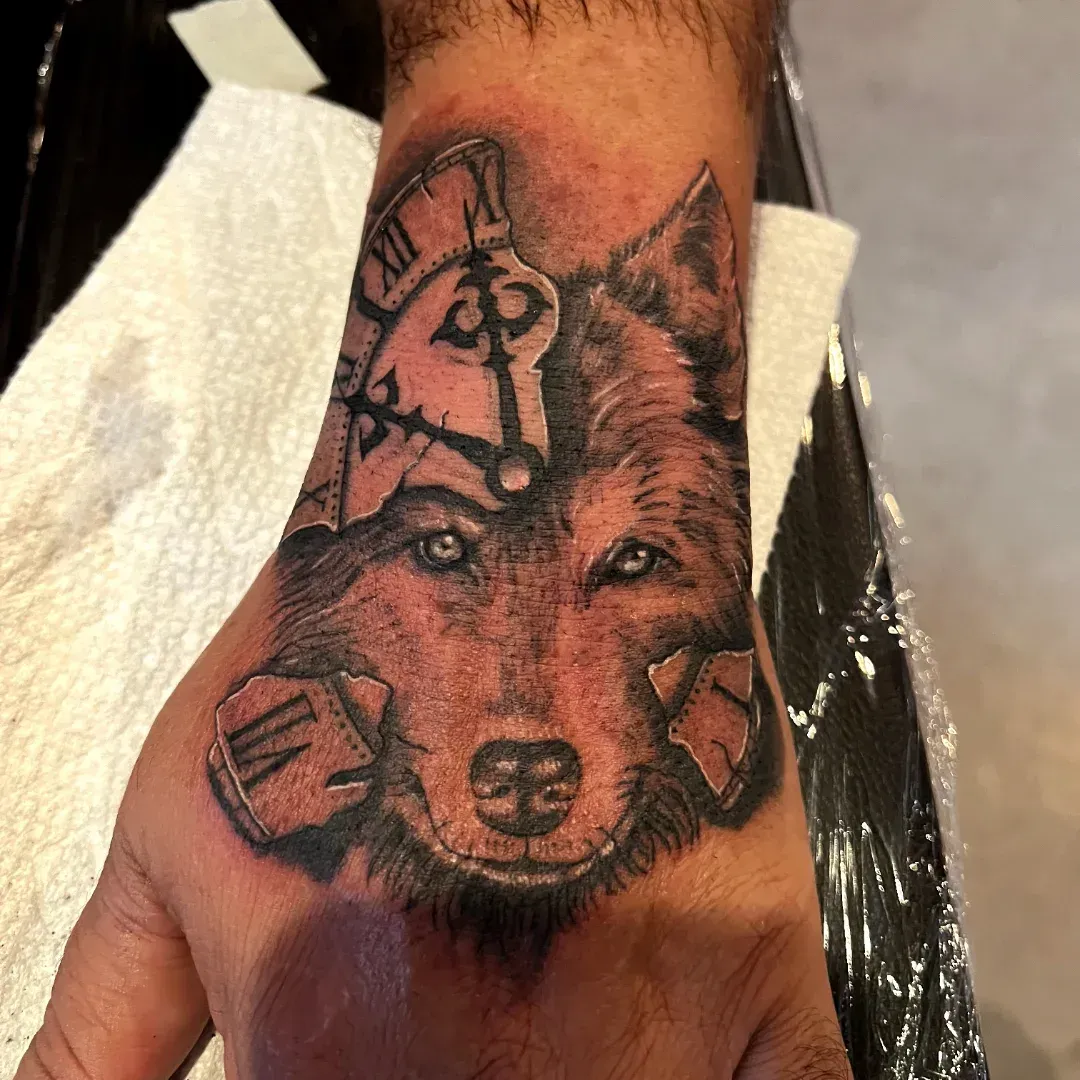 Black and grey wolf and broken clock hand tattoo, freshly done at American Ink Tattoos in Sherman Oaks.