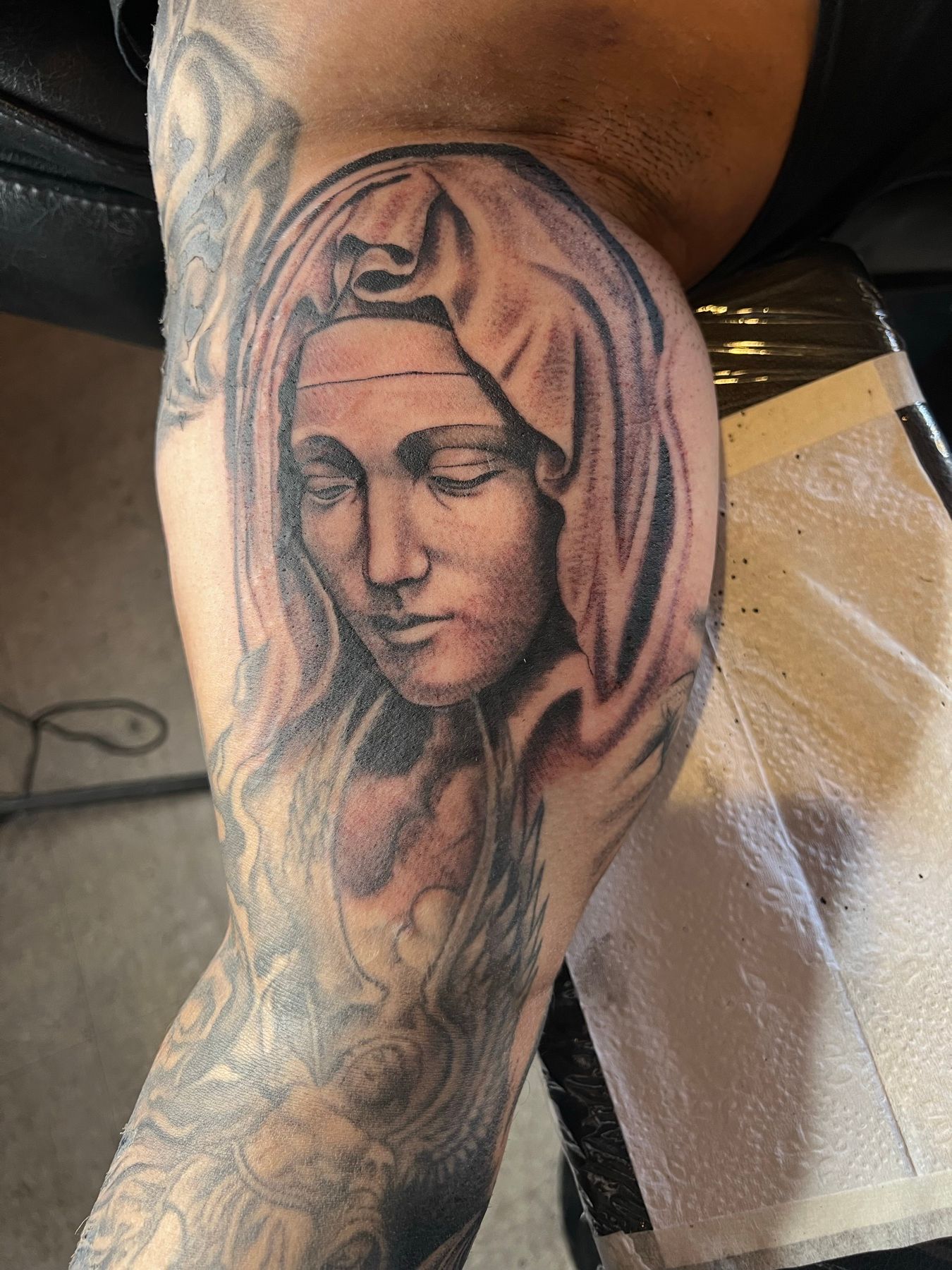 Black and grey inner arm tattoo of the Virgin Mary with a veil, by American Ink in Sherman Oaks.