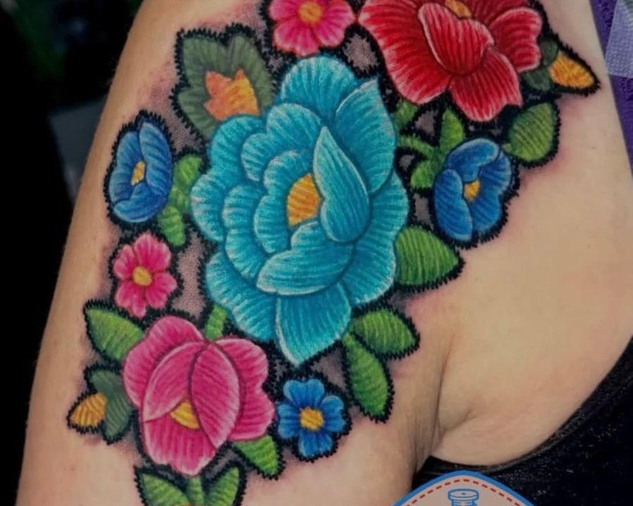 Color embroidery patch-style floral bouquet shoulder tattoo, tattooed by Rask