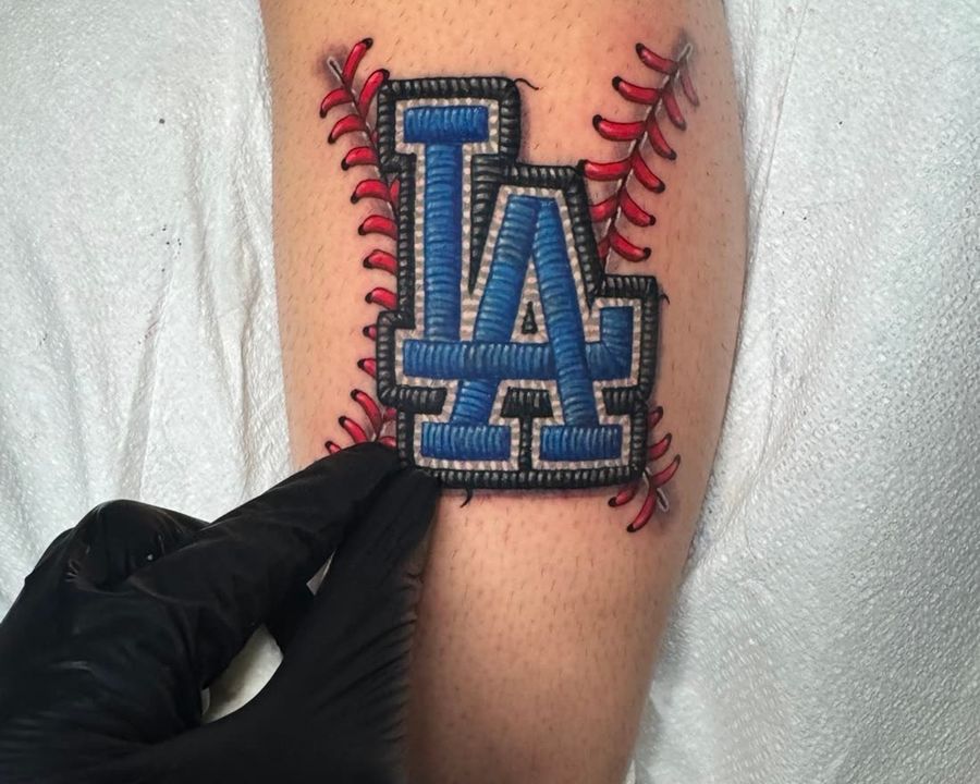 Embroidery patch-style LA Dodgers logo with red baseball stitching, tattooed by Rask
