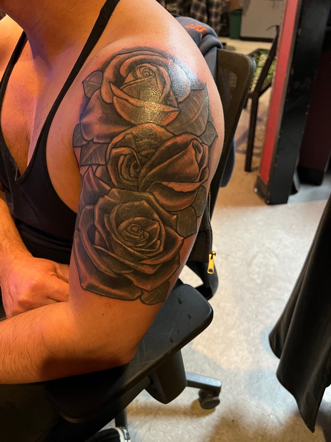 Reworked black and grey rose shoulder tattoo with deep contrast and crisp detail, by American Ink in Sherman Oaks.
